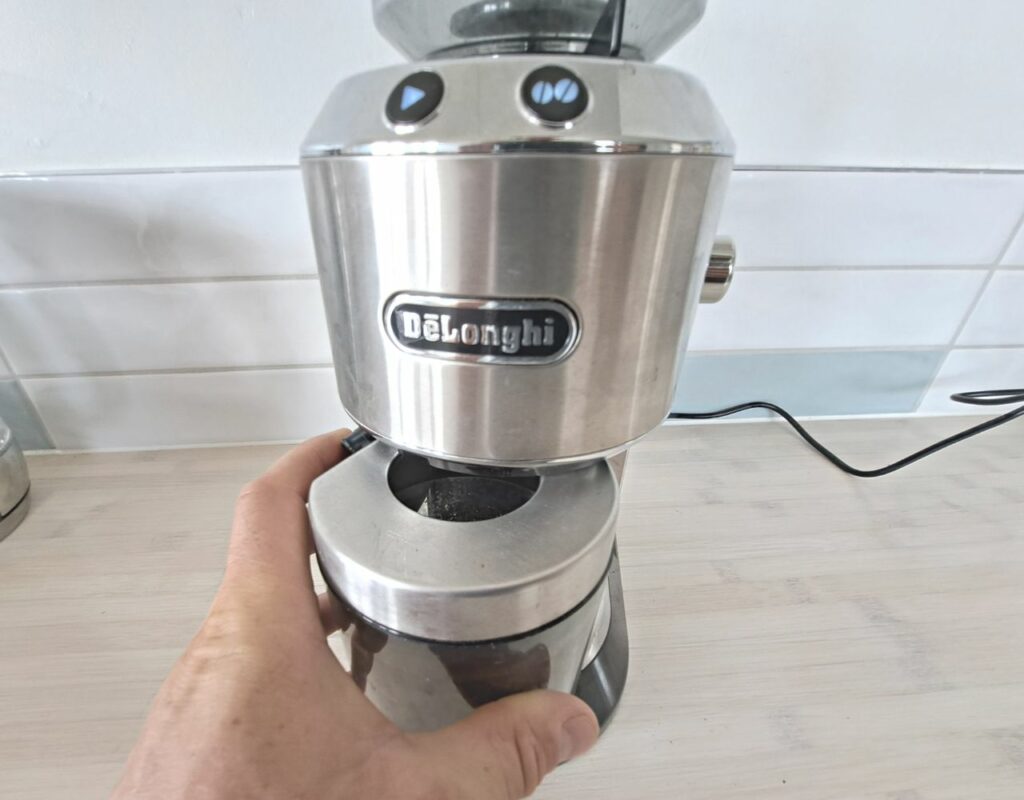 Delonghi Coffee Grinder Not Working (7 Reasons Why) 4 The Green Pods inserting the grind container into a delonghi coffee grinder