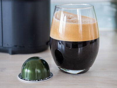 A picture of the Nespresso Stormio coffee and pod next to it