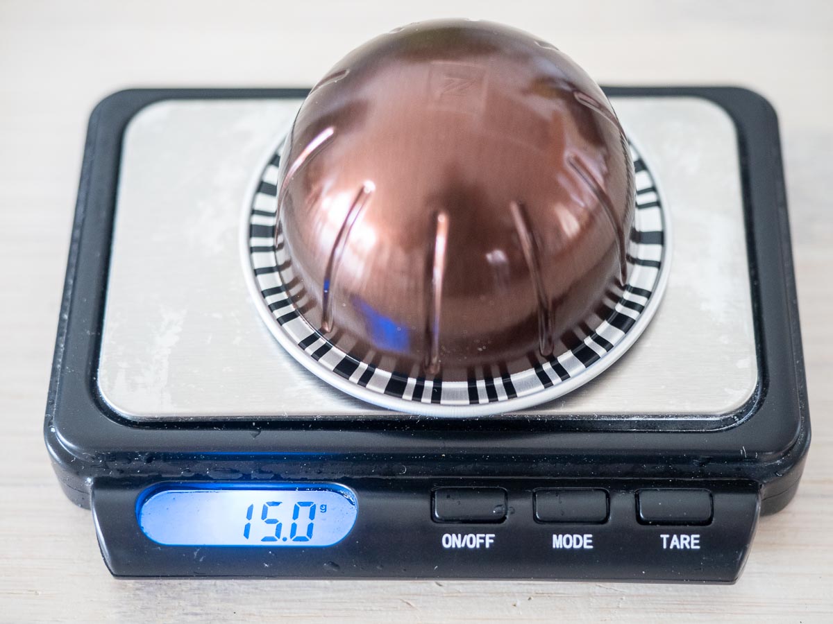 Nespresso Intenso Review And Key Info (Read Before Buying) 4 Nespresso Intenso weight stormio capsule being weighted on a set of scales